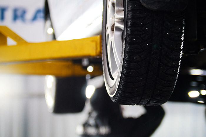 closeup of car tire on service lift